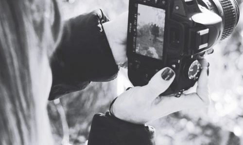 close-up-woman-photographing-from-camera